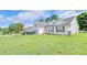 Charming home with a manicured lawn, dormer windows, and parked cars, great curb appeal at 2233 Hansford Pass, Buford, GA 30519