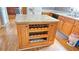 Kitchen island with wine rack and granite countertops at 2233 Hansford Pass, Buford, GA 30519