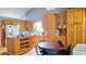 Functional kitchen with wood cabinets, eat-in table, and lots of cabinet space at 2233 Hansford Pass, Buford, GA 30519