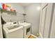 Laundry room with modern washer and dryer units and shelving at 2233 Hansford Pass, Buford, GA 30519