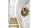 Carpeted staircase with holiday wreath for festive, seasonal charm at 2233 Hansford Pass, Buford, GA 30519