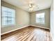 Bedroom with ceiling fan, hardwood flooring and plenty of natural light at 3948 Oak Glenn Dr, Duluth, GA 30096