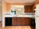 Well-lit kitchen with dark cabinets, sleek appliances, and an open view to the adjacent dining area at 3948 Oak Glenn Dr, Duluth, GA 30096