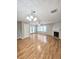 Spacious living room with hardwood floors, fireplace, stylish lighting, and ample space for comfortable seating at 3948 Oak Glenn Dr, Duluth, GA 30096