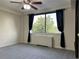 A tranquil bedroom featuring neutral walls, ceiling fan, plush gray carpeting, and lots of natural light at 2479 Peachtree Ne Rd # 317, Atlanta, GA 30305
