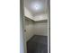This walk-in closet is carpeted and equipped with ample storage shelving at 2479 Peachtree Ne Rd # 317, Atlanta, GA 30305