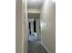 A hallway with doorways to rooms and a view of a room with a built-in at 2479 Peachtree Ne Rd # 317, Atlanta, GA 30305