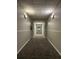 Long hallway with carpet and painted walls leads into the building at 2479 Peachtree Ne Rd # 317, Atlanta, GA 30305