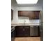 A kitchen featuring stainless steel appliances, brown cabinets, and light-colored countertops at 2479 Peachtree Ne Rd # 317, Atlanta, GA 30305