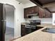Kitchen showcasing stainless steel appliances, granite countertops and wooden cabinetry at 2479 Peachtree Ne Rd # 317, Atlanta, GA 30305