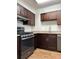 Well-lit kitchen with stainless steel appliances, granite countertops, and brown cabinetry at 2479 Peachtree Ne Rd # 317, Atlanta, GA 30305