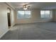 View of a living room leading into the kitchen, featuring a fan and abundant sunlight at 2479 Peachtree Ne Rd # 317, Atlanta, GA 30305