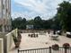 Expansive rooftop terrace with dining tables, grills, potted plants, and scenic treetop views at 2479 Peachtree Ne Rd # 317, Atlanta, GA 30305