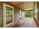 Relaxing covered porch with stained wood flooring and ceiling at 4615 Gresham Rd, Douglasville, GA 30134