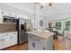 Bright kitchen with white cabinets, stainless steel appliances, and a center island, seamlessly connected to the breakfast nook at 4615 Gresham Rd, Douglasville, GA 30134