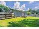 Spacious backyard with a wooden fence, lush lawn and a small deck at 502 Snowfall Ter, Palmetto, GA 30268