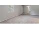 Large unfinished basement with neutral carpet, bright window, and neutral paint at 502 Snowfall Ter, Palmetto, GA 30268
