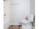 Clean, bright bathroom features a white toilet, tub and modern finishes at 502 Snowfall Ter, Palmetto, GA 30268