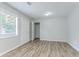 Bright bedroom with hardwood floors and a large window with blinds at 502 Snowfall Ter, Palmetto, GA 30268