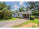Charming single-story home with a covered carport, lush landscaping and well-manicured lawn at 502 Snowfall Ter, Palmetto, GA 30268