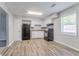Well-lit kitchen with white cabinets, black appliances, and new flooring at 502 Snowfall Ter, Palmetto, GA 30268