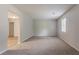 Spacious living room with a carpeted floor, bright window, and neutral paint at 502 Snowfall Ter, Palmetto, GA 30268
