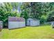 Backyard featuring two storage sheds for storing lawn care tools and equipment at 502 Snowfall Ter, Palmetto, GA 30268
