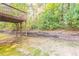 View of backyard and wooden retaining wall with an under-deck area at 5033 Kens Ct, Stockbridge, GA 30281