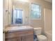 Bathroom with tub/shower combination, window, sink and vanity with wood cabinets at 5033 Kens Ct, Stockbridge, GA 30281