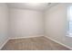 Well-lit bedroom with neutral paint, carpet, and a window bringing in sunlight at 5033 Kens Ct, Stockbridge, GA 30281