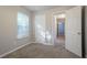 Bedroom with closet and view into the hallway, with neutral walls and carpeted floor at 5033 Kens Ct, Stockbridge, GA 30281