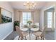 Cozy dining room with elegant chandelier, round table, and bright natural light at 5033 Kens Ct, Stockbridge, GA 30281