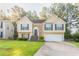 Charming two-story home with a manicured lawn, brick accents, and attached two-car garage at 5033 Kens Ct, Stockbridge, GA 30281