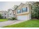 Charming two-story home with a manicured lawn, brick accents, and attached two-car garage at 5033 Kens Ct, Stockbridge, GA 30281