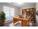 Bright home office with large window, wooden desk, and lots of storage at 5033 Kens Ct, Stockbridge, GA 30281