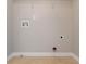 Laundry room hookups with beige walls and light-colored vinyl flooring at 5033 Kens Ct, Stockbridge, GA 30281