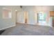 Spacious living room with neutral paint, plush carpet, and an open floor plan to a dining area at 5033 Kens Ct, Stockbridge, GA 30281
