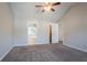 Vaulted ceiling in main bedroom showing carpeted floors and entry to bathroom with tub at 5033 Kens Ct, Stockbridge, GA 30281