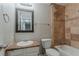 Bathroom with granite counter tops, decorative mirror and tile accents in shower at 5383 Forest East Ln, Stone Mountain, GA 30088
