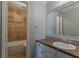 Bathroom with granite counters, large framed mirror, and tiled shower/tub at 5383 Forest East Ln, Stone Mountain, GA 30088