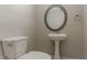 The powder room features a pedestal sink, oval mirror, and toilet at 5383 Forest East Ln, Stone Mountain, GA 30088