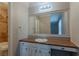 Bathroom with granite counters, vanity with lighting, and view to tiled shower/tub at 5383 Forest East Ln, Stone Mountain, GA 30088