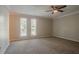 Large bedroom with plush carpet, crown molding, and windows providing ample natural light at 5383 Forest East Ln, Stone Mountain, GA 30088