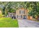 Inviting two-story home with a well-maintained lawn, black shutters, a chimney, and a cozy front entrance at 5383 Forest East Ln, Stone Mountain, GA 30088