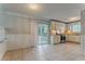Spacious kitchen and dining area showcasing tile flooring, a large sliding door to the backyard, and white cabinetry at 5383 Forest East Ln, Stone Mountain, GA 30088