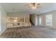 Carpeted living room featuring steps to another room and view of the kitchen at 5383 Forest East Ln, Stone Mountain, GA 30088