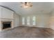 Carpeted living room featuring a vaulted ceiling, fireplace, and large windows allowing natural light at 5383 Forest East Ln, Stone Mountain, GA 30088