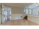 An open-concept living room showing hardwood floors, steps to another room, and natural light at 5383 Forest East Ln, Stone Mountain, GA 30088