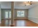 An open-concept living room featuring hardwood floors and plenty of natural light at 5383 Forest East Ln, Stone Mountain, GA 30088