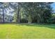 Expansive backyard with lush green lawn and mature trees offering privacy at 573 Allgood Rd, Stone Mountain, GA 30083